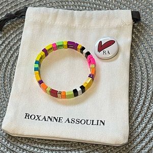Roxanne Assoulin Enamel coated stretch bracelet with a gold tone logo
